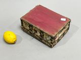 a small box with a lemon next to it on a table