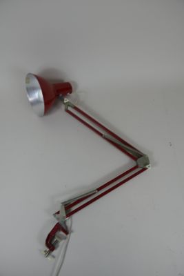 two red lamps that are on the wall next to each other