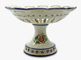 a white bowl with blue trim and a flower design on it