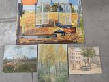 paintings on the floor of a room with a view of a house