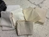 many different types of cloths laid out on a table
