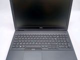the dell laptop is sitting on a white surface with a black keyboard