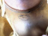 a close up of a brown leather boot with a tag on it