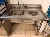 a stainless steel sink in a kitchen next to a stove