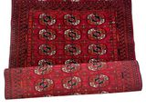 a red rug on a white background with fringes