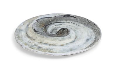 a white plate with a swirl on it on a white surface
