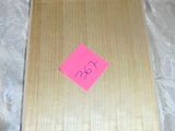 a piece of wood with a pink sticker on it