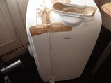 a small white refrigerator in the corner of a room
