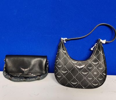 two purses are sitting next to each other on a table