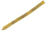 a close up of a gold bracelet on a white background