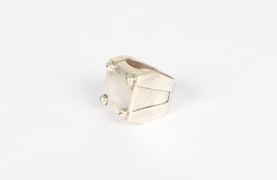 a close up of a silver ring on a white surface