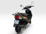 a scooter that is parked on a white surface