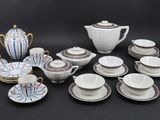 many different types of tea cups and saucers on the table