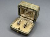 a small box with two rings inside of it