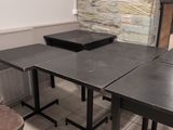 a table and two chairs in a room with a stone wall