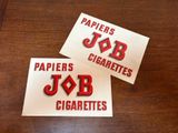 two stickers that say papers cigarettes and job cigarettes on them