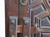a close up of a door handle on a wooden door
