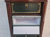 a wooden cabinet with two drawers on top of it