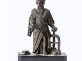 a statue of a man with a hat and a cane