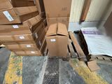 a pile of boxes sitting on the floor next to a pallet