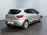 the rear end of a silver car in a white room