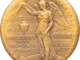 an image of a gold medal with an angel on it