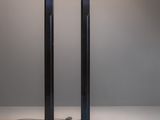 pair of black metal floor lamps on a white surface