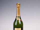 a bottle of champagne on a white surface