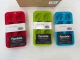 three different colored ice trays sitting next to each other on a table