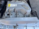 a small engine in the back of a silver car