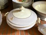 many plates and bowls that are sitting on the floor