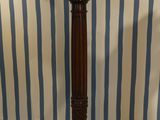 a tall wooden pole with a clock on top of it