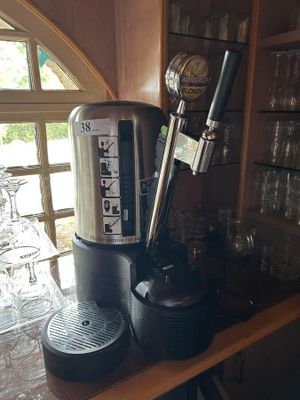 a coffee maker sitting on top of a wooden counter