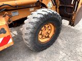 a tractor that is parked on the side of the road