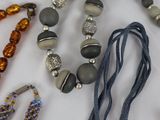 a lot of necklaces that are laying on a table