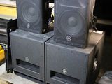three speakers sitting on a pallet in a room