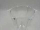 clear glass bowl on a white surface with a small hole in the middle