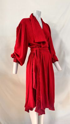 red dress on mannequin base with white background