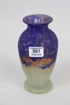 a purple vase with a tag on it sitting on a table