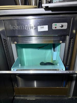 an ice maker that is sitting in the middle of a counter