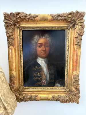 painting of a man in a blue coat with a white collar and a gold frame
