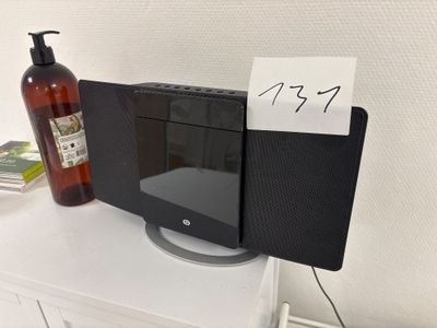 a picture of a microwave on a table with a note attached to it
