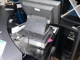 an image of a cluttered office with a computer and printer