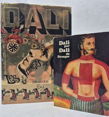 two books on display on a white surface with one of them in front of the other