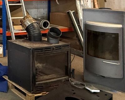 a small stove sitting in the middle of a room