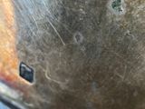 a close up of a metal plate with a hole in it