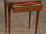 a small wooden table with a drawer on top of it