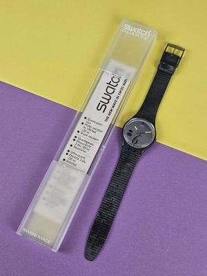 the watch is sitting next to the packaging for the watch