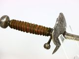 an image of a close up of a sword on a stand