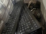two black keyboards sitting on top of each other in a basket